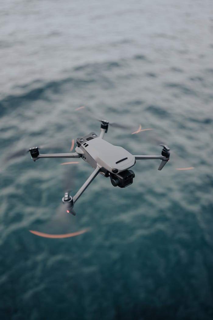 Aerial view of a drone flying over the sea, showcasing technology in action.
